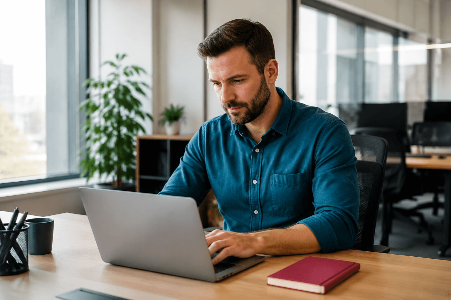 Professional working on laptop while adapting to workplace changes